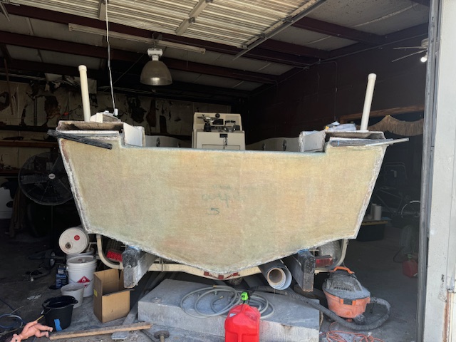 New fiberglass laminate laid into a boat hull during structural repair